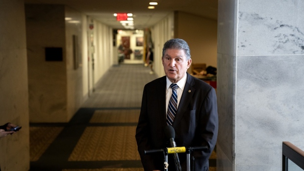 Senator Joe Manchin, a Democrat from West Virginia, speaks to members of the media outside his office at the Hart Senate Office building in Washington, D.C., U.S., on Tuesday, Jan. 4, 2022. Senate Democrats began their new year seeking a path forward on the White House's stalled domestic economic agenda, hoping to pass a slimmed-down version before midterm election campaigns begin.
