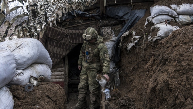 A Ukrainian soldier, pets a cat in a trench on the front line on December 12, 2021 in Zolote, Ukraine.