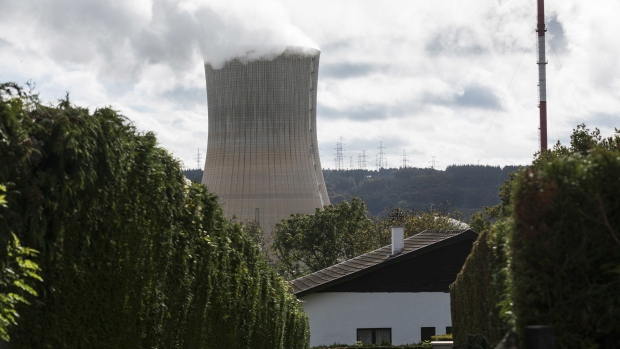 A cooling tower at the Tihange nuclear power station, operated by Engie SA, beyond a residential house in Huy, Belgium, on Tuesday, Oct. 26, 2021. As recently as 2000, Europe generated almost a third of its electricity from nuclear fission, the highest proportion of any region.