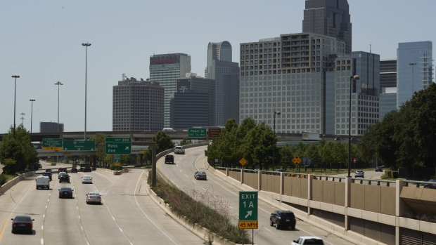 Vehicles travel along a highway in Dallas, Texas, U.S., on Monday, July 26, 2021. Heat bears down on Texas and the Great Plains this week, driving temperatures in Dallas above the 100-degree mark for the first time this year.
