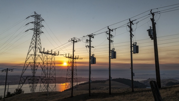 Power lines and transmission towers at sunrise in Crockett, California, U.S., on Wednesday, Aug. 19, 2020. On Tuesday -- just as California was preparing to plunge as many as 6 million people into darkness to save the power system from one of the worst heat waves in generations -- blazes torched tens of thousands of acres, forcing people to flee their homes and prompting California Governor Gavin Newsom to declare a state of emergency only days into the peak of the wildfire season. Photographer: David Paul Morris/Bloomberg