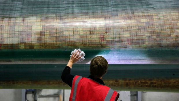 An employee performs quality control checks on a constructed wind turbine blade before it is painted at the Siemens AG turbine blade plant in Hull, U.K., on Thursday, Oct. 6, 2016. Ports like Grimsby and Hull are within 12 hours sailing time of about 22 gigawatts of built and planned wind farm capacity in the North Sea.