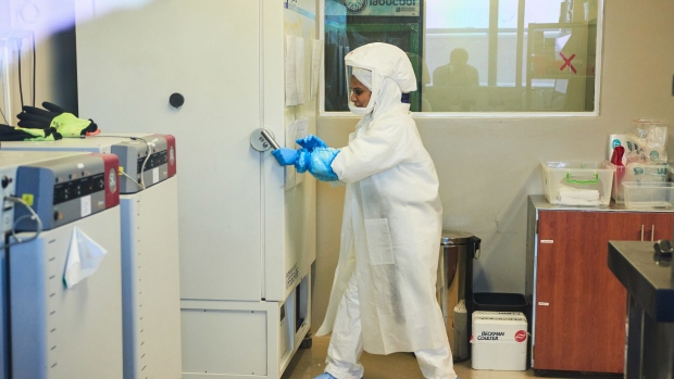 A technician wearing a full body protection suit works inside a biosafety level 3 Covid-19 research laboratory at the African Health Research Institute (AHRI) in Durban, South Africa, on Wednesday, Dec. 15, 2021. South Africa’s hospital admission rate as a percentage of new Covid-19 cases identified dropped sharply in the second week of the current infection wave driven by the omicron variant, compared with the same week of the third wave. Photographer: Waldo Swiegers/Bloomberg