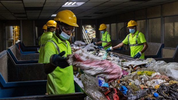 Workers sort solid waste material in the material recovery facility at the Bee'ah waste management complex in Sharjah, United Arab Emirates, on Tuesday, July 13, 2021. The U.A.E. is building one of the world’s largest waste-to-energy plants to deal with its growing trash load as the Persian Gulf state has few options to stop the giant heaps of plastic, paper and organic waste on the outskirts of its desert cities from piling higher.