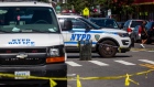 NYPD vehicles parked in front of a crime scene in the 73th precinct in the Brownsville neighborhood in the Brooklyn borough of New York, U.S., on Sunday, Sept. 19, 2021. In fiscal 2020, New York City police officers logged more overtime hours than any other big city in the U.S., and violent crime rates still went up. Photographer: Michael Nagle/Bloomberg