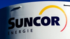 Suncor Energy Inc. signage is displayed on a petroleum storage tank in Montreal, Quebec, Canada, on Sunday, Nov. 6, 2011. Suncor Energy completed maintenance at its Terra Nova Floating Production, Storage and Offloading site off the coast of Newfoundland and Labrador, the company said in a statement on its website. Photographer: Bloomberg/Bloomberg