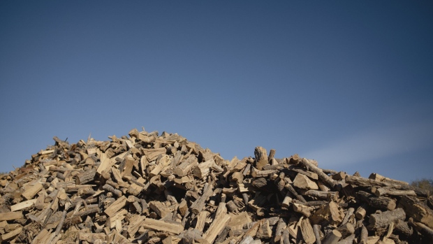 A worker splits wood to meet soaring demand. Photographer: Adria Malcolm /Bloomberg