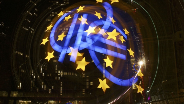 The light trail from a euro sign sculpture is seen in this long-exposure photograph taken outside the European Central Bank's (ECB) headquarters in Frankfurt, Germany, on Tuesday, Oct. 30, 2012. The European Central Bank said euro-area banks increased tightening of credit standards to businesses in the third quarter and expect a similar degree of tightening in the fourth. Photographer: Bloomberg/Bloomberg