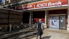 A customer covering his mouth and nose approaches an ICICI Bank Ltd. branch in Mumbai, India, on Monday, May 4, 2020. India's central bank Governor Shaktikanta Das and the chief executive officers of the nation's banks have discussed ways to ensure credit flow to businesses once the world's toughest stay-at-home order ends.