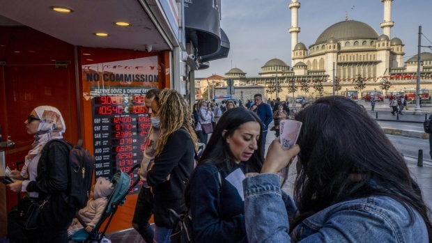Customers at a currency exchange bureau on Taksim square in Istanbul, Turkey, on Friday, Oct. 15, 2021. Turkish President Recep Tayyip Erdogan fired monetary policy makers wary of cutting interest rates further, driving the lira to record lows against the dollar with his midnight decree.