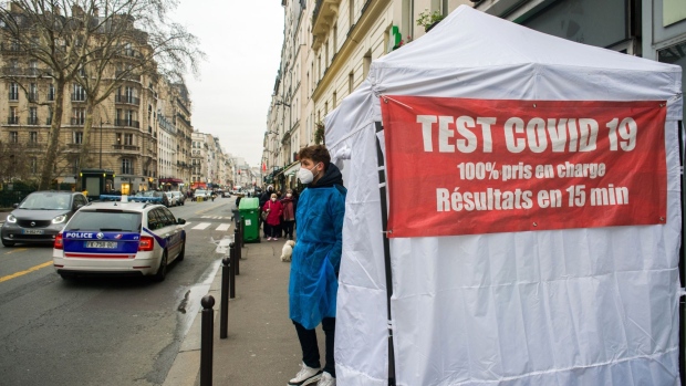 A heath worker waits outside a pop-up Covid-19 testing tent in Paris, France, on Wednesday, Jan. 12, 2022. The pandemic in France has become a live political issue as authorities are struggling to contain the spread of the omicron variant and new infections hit a record.