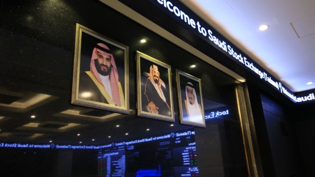 Photographs of, from left to right, Saudi Arabia's Crown Prince Mohammed bin Salman, former King Abdulaziz Al-Saud and King Salman Bin Abdulaziz sit on display inside the Saudi Stock Exchange, also known as Tadawul, sit in Riyadh, Saudi Arabia, on Sunday, Nov. 4, 2018. A month after the murder of government critic Jamal Khashoggi in the Saudi consulate in Istanbul, bankers say the rewards of doing business with the oil-rich kingdom far outweigh the risks.