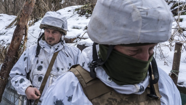 PISKY, UKRAINE - JANUARY 18: Mykola (L) and Viktor, Ukrainian soldiers with the 56th Brigade, in a trench on the front line on January 18, 2022 in Pisky, Ukraine. Negotiations last week between Russian and Western diplomats, who were hoping to defuse the prospect of a Russian invasion of Ukraine, ended inconclusively. In recent months, Russia has amassed forces and military equipment near the Ukrainian border, raising the specter of a possible invasion of the country's east, where separatists have waged a nearly 8-year war against the Ukrainian government. (Photo by Brendan Hoffman/Getty Images)