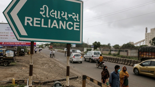 A road sign for the Reliance Industries Ltd. oil refinery in Jamnagar, Gujarat, India, on Saturday, July 31, 2021. The Indian city of Jamnagar is a money-making machine for Asia's richest man, Mukesh Ambani, processing crude oil into fuel, plastics and chemicals at the world's biggest oil refining complex that can produce 1.4 million barrels of petroleum a day.