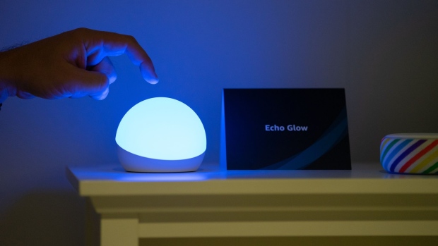 A worker demonstrates an Amazon.com Inc. Echo Glow smart lamp during an unveiling event at the company's headquarters in Seattle, Washington, U.S., on Wednesday, Sept. 25, 2019. Amazon.com Inc. defended the privacy features of its Alexa digital assistant -- and introduced some new tools to reassure users -- following months of debate about the practices of the technology giant and its largest competitors. Photographer: Chloe Collyer/Bloomberg