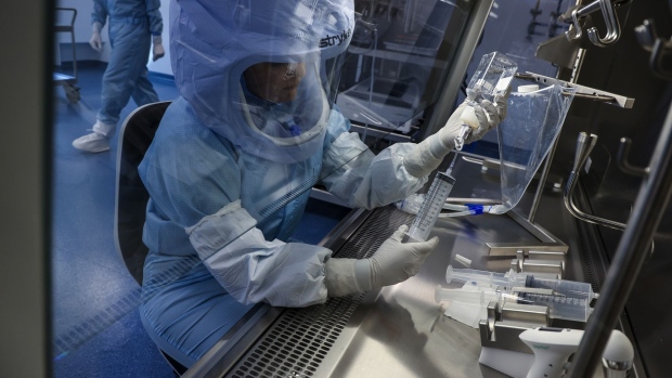 An employee prepares a syringe of raw materials for messenger RNA (mRNA), the first step of Covid-19 vaccine production, at the BioNTech SE laboratory in Marburg, Germany, on Saturday, March 27, 2021. BioNTech and Pfizer Inc. raised this year’s production target for their Covid-19 vaccine to as many as 2.5 billion doses, with the German biotech’s chief executive predicting a version of the shot that can be stored in refrigerators will be ready within months. Photographer: Cyril Marcilhacy/Bloomberg