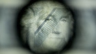 The face of President George Washington is seen through a loupe on a 50 subject one dollar note sheet after being printed by an intaglio printing press in this arranged photograph at the U.S. Bureau of Engraving and Printing in Washington, D.C., U.S. Photographer: Andrew Harrer