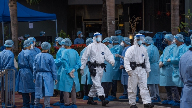 Health officials wearing personal protective equipment at the Kwai Chung Estate public housing complex in Hong Kong, on Jan. 23.