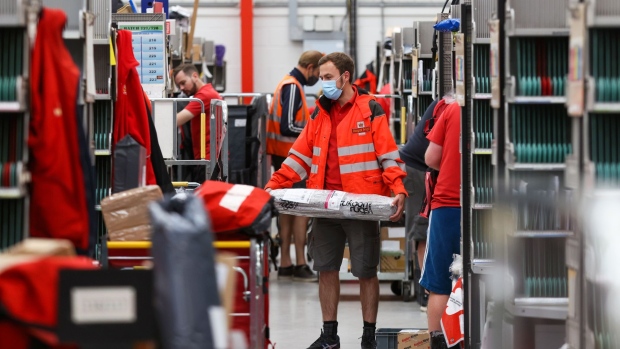 An employee sorts through parcels at the Royal Mail Plc sorting office in Chelmsford, U.K., on Thursday, May 13, 2021. Royal Mail are due to report earnings on Thursday, May 20.