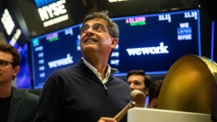 Sandeep Mathrani, chief executive officer of WeWork, looks at a monitor on the floor of the New York Stock Exchange (NYSE) in New York, U.S., on Thursday, Oct. 21, 2021. SoftBank will finally get a chance to start recouping some of the more than $17 billion it poured into WeWork when the company lists its shares on the NYSE.