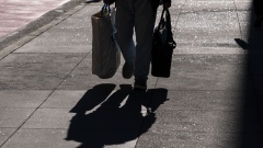 A pedestrian carries shopping bags in San Francisco, California. Photographer: David Paul Morris/Bloomberg