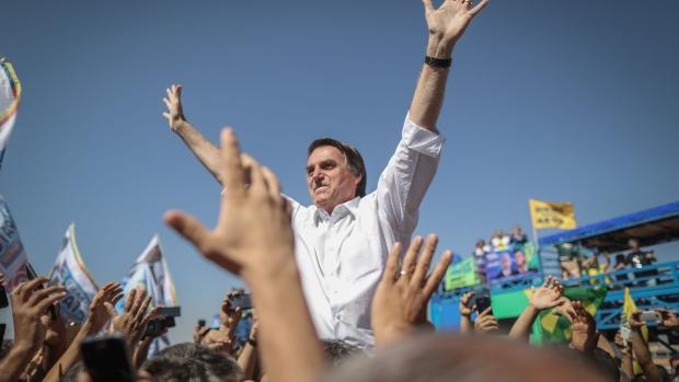 Jair Bolsonaro, presidential candidate for the Social Liberal Party (PSL), waves to supporters during a campaign rally in Taguatinga, Brazil, on Wednesday, Sept. 5, 2018. In polls which exclude former president Luiz Inacio Lula da Silva, Bolsonaro leads the pack ahead of Brazilian elections.