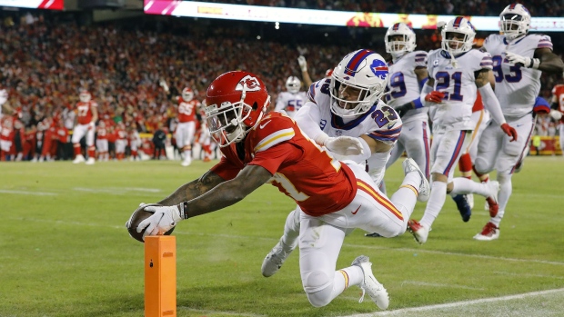 KANSAS CITY, MISSOURI - JANUARY 23: Mecole Hardman #17 of the Kansas City Chiefs dives to score a 25 yard touchdown against Micah Hyde #23 of the Buffalo Bills during the third quarter in the AFC Divisional Playoff game at Arrowhead Stadium on January 23, 2022 in Kansas City, Missouri. (Photo by David Eulitt/Getty Images)