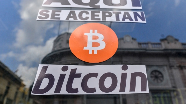 Signage announcing the acceptance of Bitcoin as a payment method outside a cellphone accessories shop in the Historical Center of San Salvador, El Salvador, on Thursday, Sept. 30, 2021. The government's new digital wallet, called Chivo, was designed to facilitate Bitcoin transactions, but the ease with which users can top up their balances and switch instantly between dollars and tiny, fractional amounts of the cryptocurrency makes it a perfect tool for speculation. Photographer: Camilo Freedman/Bloomberg