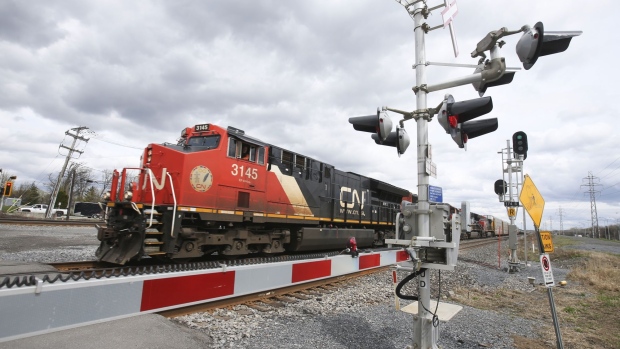 A Canadian National Railway locomotive pulls a train in Montreal. Photographer: Christinne Muschi/Bloomberg