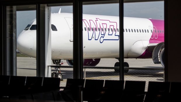 A Wizz Air Holdings Plc passenger aircraft parked at a gate at Budapest Ferenc Liszt International Airport in Budapest, Hungary, on Wednesday, Aug. 4, 2021. The Hungarian government has made a non-binding offer to buy Budapest Airport, according to people familiar with the matter, as Prime Minister Viktor Orban seeks to gain control of what had been one of the fastest growing hubs in the region before the coronavirus pandemic.
