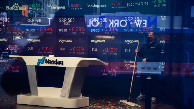A worker sweeps up confetti after the opening bell at the Nasdaq MarketSite in New York. Photographer: Michael Nagle/Bloomberg