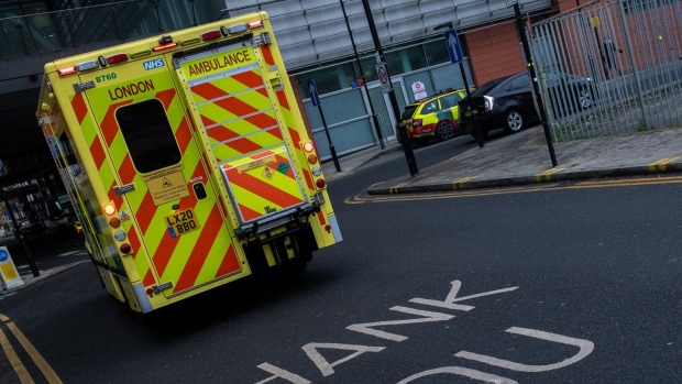 An ambulance passes supportive messaging for the NHS on the road at The Royal London Hospital in London. Photographer: Chris J. Ratcliffe/Bloomberg