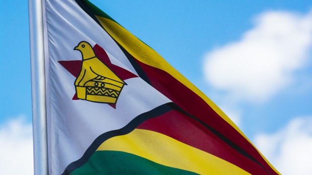 A Zimbabwean national flag flies in Harare, Zimbabwe, on Tuesday, July 31, 2018. Zimbabwe's main opposition party said it was well ahead in the first election of the post-Robert Mugabe era and it's ready to form the next government, as unofficial results began streaming in. Photographer: Waldo Swiegers/Bloomberg