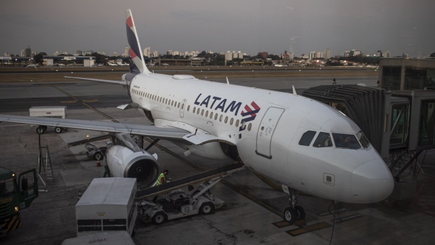 An aircraft operated by Latam Airlines Group SA sits on the tarmac at Congonhas Airport in Sao Paulo.