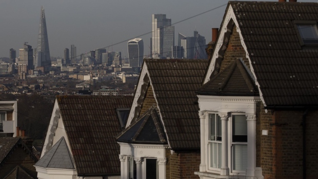 A terrace of residential houses in the Dulwich district in view of skyscrapers in the City of London, U.K., on Tuesday, Nov. 24, 2020. Asking prices for U.K. homes slipped this month as owners sought to get sales agreed in time to benefit from a temporary tax cut.