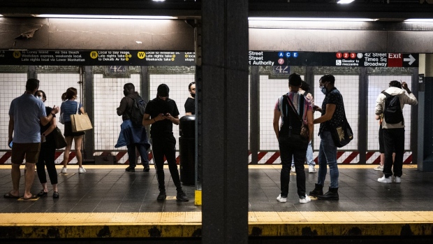 Commuters on a platform at the 42nd Street subway station in New York, U.S., on Friday, July 2, 2021. New York's Metropolitan Transportation Authority needs more riders to help support a record $51.5 billion capital plan to expand service throughout the New York City region and modernize its infrastructure.