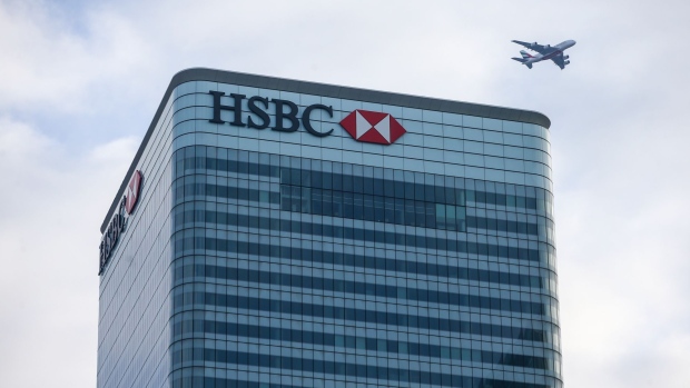 An aircraft passes over the top of the global headquarters for HSBC Holdings Plc in Canary Wharf financial, business and shopping district, in London, U.K., on Thursday, Jan. 7, 2021. Persimmon Plc, the U.K.’s biggest housebuilder, said the long-term outlook for the country’s housing market remained resilient despite the economic gloom and latest national lockdown. Photographer: Hollie Adams/Bloomberg