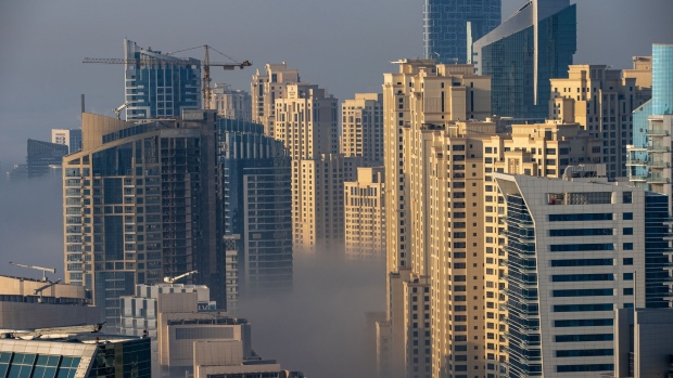 Morning fog shrouds residential and commercial skyscrapers in the Dubai Marina district of Dubai, United Arab Emirates, on Sunday, Jan. 17, 2021. Dubai is hoping one of the world’s fastest vaccination programs and rapid testing technology will help achieve its goal of holding the Expo 2020 event this year, after the coronavirus pandemic forced a delay.