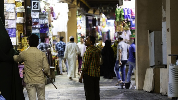 Visitors walk past traders in the Mutrah souq in Muscat, Oman, on Sunday, May 6, 2018. Being the Switzerland of the Gulf served the country well over the decades, helping the sultanate survive, thrive and make it a key conduit for trade and diplomacy in the turbulent Middle East.
