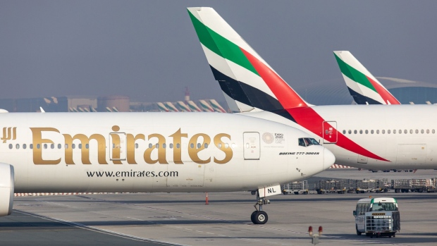 A Boeing Co. 777-300 aircraft, operated by Emirates, taxis at Dubai International Airport in Dubai, United Arab Emirates, on Monday, May 18, 2020. Emirates Group is considering plans to cut about 30,000 jobs as the operator of the world’s largest long-haul carrier seeks to reduce costs after the coronavirus pandemic grounded air travel.