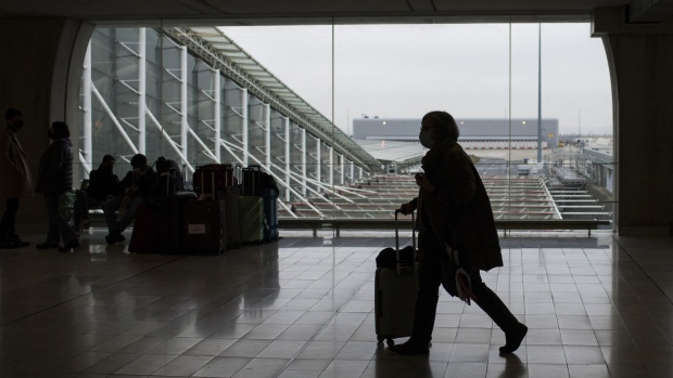 A passenger wheels luggage at Paris-Charles de Gaulle airport in Paris. Photographer: Nathan Laine/Bloomberg