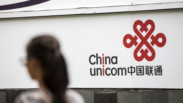 Signage for China Unicom Ltd. is displayed outside a store in Shanghai, China, on Monday, Aug. 21, 2017. Shares of Unicom Group's key units in Shanghai and Hong Kong rose after China's second-largest wireless carrier announced a $11.7 billion stock sale as part of a government push to draw private capital into its state-owned enterprises. Photographer: Qilai Shen/Bloomberg
