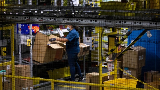 A worker sorts merchandise at an Amazon fulfillment center on Cyber Monday in Robbinsville, New Jersey, U.S., on Monday, Nov. 29, 2021. Adobe Digital Economy Index is expecting Cyber Monday to bring the biggest holiday shopping of the year, with consumers projected to spend between $10.2 billion and $11.3 billion. Photographer: Michael Nagle/Bloomberg