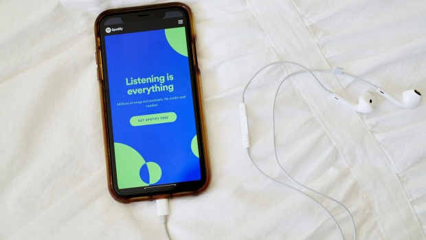The website home screen for Spotify is displayed on a smartphone in an arranged photograph taken in Little Falls, New Jersey, U.S., on Thursday, Oct. 8, 2020. Spotify has invested hundreds of millions of dollars acquiring podcast studios such as Gimlet Media and the Ringer, hoping to attract new users and advertisers to what has been a music app. Photographer: Gabby Jones/Bloomberg