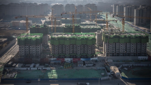 Unfinished apartment buildings at the construction site of a China Evergrande Group development in Beijing, China, on Thursday, Jan. 6, 2022. Evergrande is seeking to delay an option for investors to demand early repayment on one of its yuan-denominated bonds, in the latest sign of distress amid a broader real estate debt crisis.