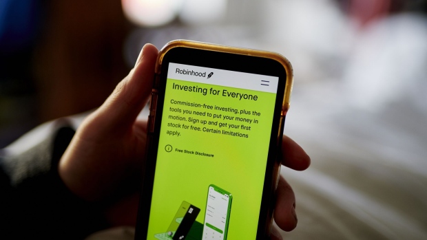 The Robinhood website home screen on a smartphone arranged in the Brooklyn borough of New York, U.S., on Saturday, Dec. 19, 2020. Robinhood Markets will pay $65 million to settle allegations that it failed to properly inform clients it sold their stock orders to high-frequency traders and other firms, putting a major compliance headache behind the brokerage even as new ones emerge. Photographer: Gabby Jones/Bloomberg