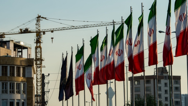 National flags of Iran line a section of the Hashemi Rafsanjani highway as a construction crane stands beyond in Tehran, Iran, on Saturday, Nov. 3, 2018. Iran’s Supreme Leader Ayatollah Khamenei said U.S. President Donald Trump’s policies are opposed by most governments and fresh sanctions on the Islamic Republic only serve to make it more productive and self-sufficient, the semi-official Iranian Students’ News Agency reported. Photographer: Ali Mohammadi/Bloomberg