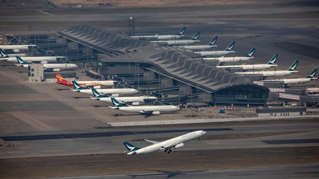 An aircraft operated by Cathay Pacific Airways Ltd. takes off from the Hong Kong International Airport in Hong Kong, China, on Thursday, Jan. 6, 2022. Hong Kong is imposing strict new virus control measures for the first time in almost a year as the highly transmissible omicron variant seeps into the community and threatens to spur a winter wave.
