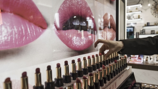 A sales assistant arranges lipsticks at an Estee Lauder Companies Inc. store in the Raffles City shopping mall in Shanghai, China, on Wednesday, May 31, 2017. Retail cosmetics sales for all companies will total $7.4 billion in China in 2021 from $4.3 billion last year, forecasts Euromonitor. Fueling growth are social media websites, such as Weibo, Youku, iQiyi and Tudou, that women are increasingly turning to for tutorials on everything from shading eyes to highlighting cheekbones. Photographer: Qilai Shen/Bloomberg