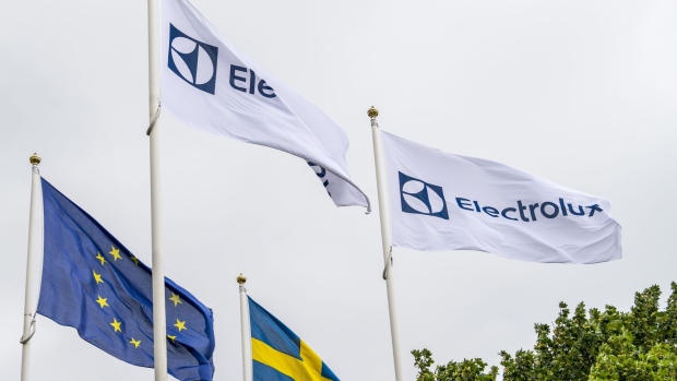 The flag of the European Union (EU) and the Swedish national flag fly alongside flags bearing the Electrolux AB logo at the company's headquarters in Stockholm. Photographer: Mikael Sjoberg/Bloomberg